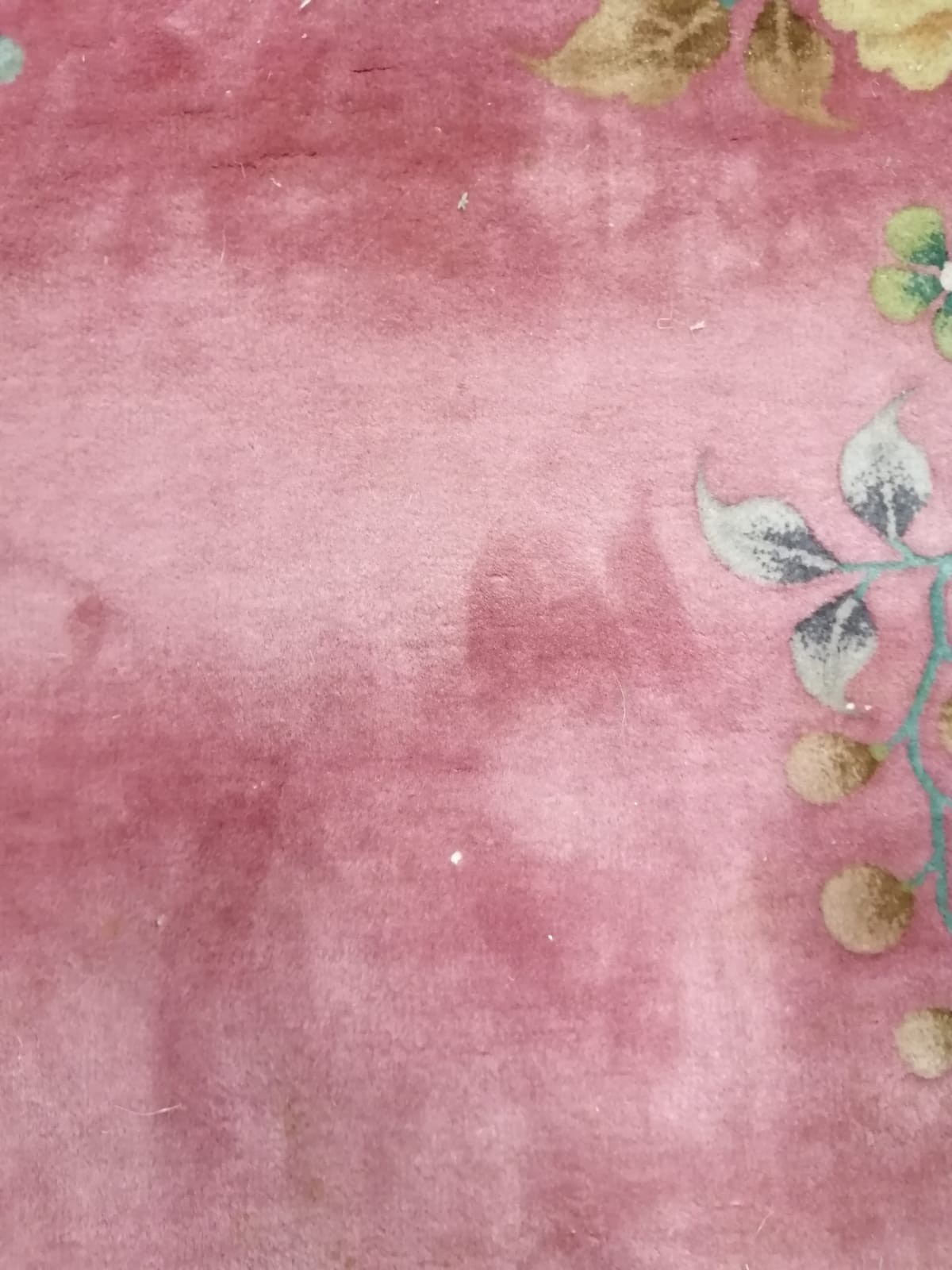 A large early 20th century Chinese cerise ground floral ground carpet, 530 x 358cm